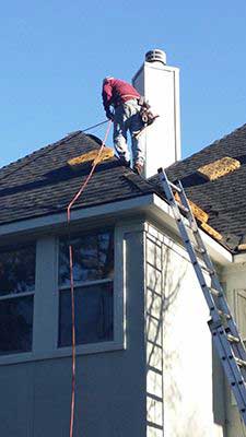 Roofer replacing roof shingles.