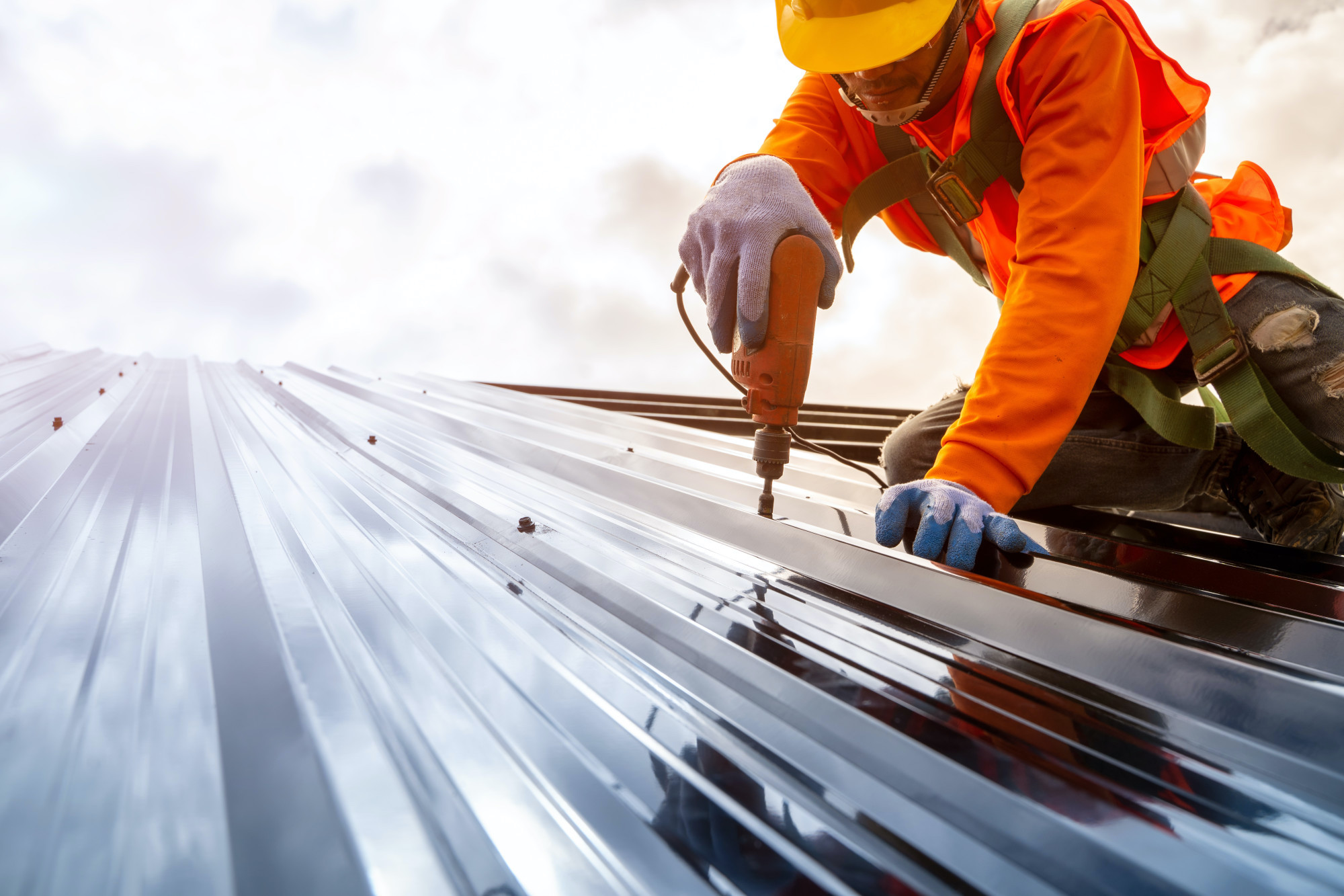 Commercial roofer installing a new metal roof in San Antonio