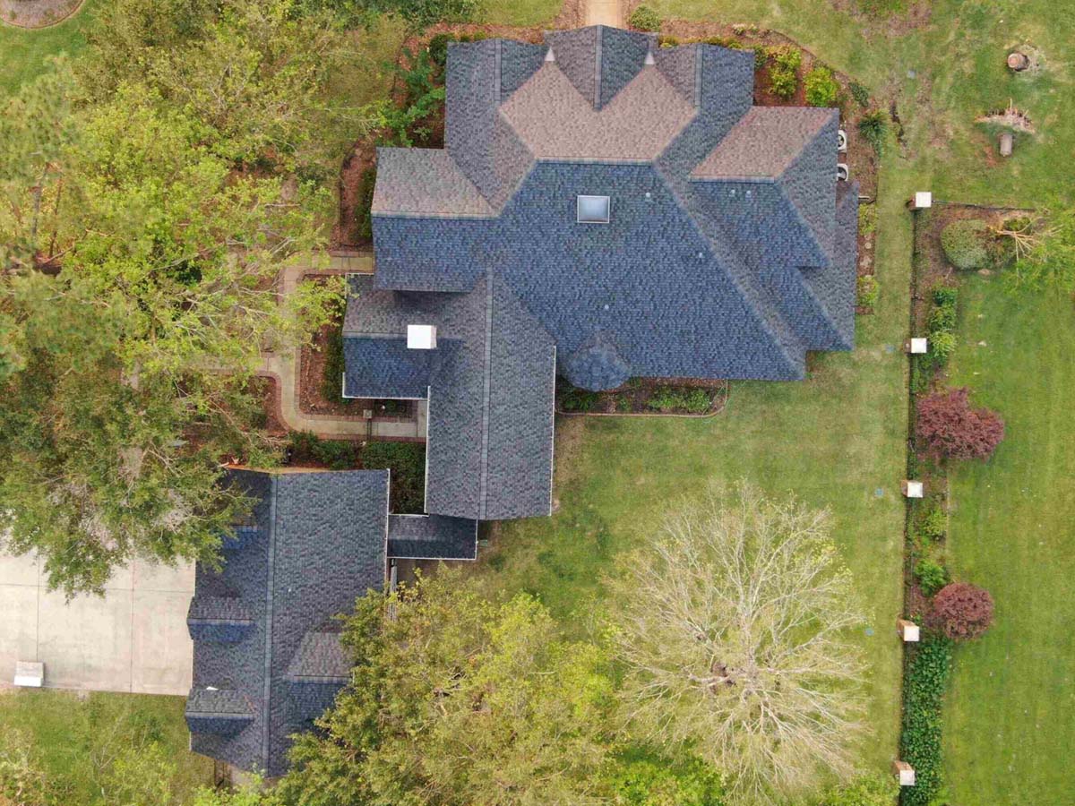 A home and garage with a beautiful new roof.